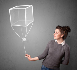 Wall Mural - Woman holding a cube balloon