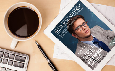 Wall Mural - tablet pc showing magazine on screen with a cup of coffee on a d