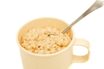 Wall Mural - Cooked Oatmeal in a Cup with Spoon