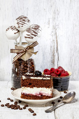 Wall Mural - Chocolate and cherry cake on white plate. Cake pops in glass jar