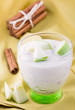 Delicious yogurt in glass with apple and cinnamon