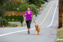 Dog Jogging With Woman