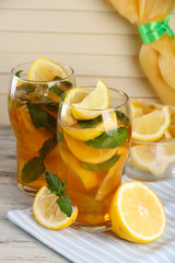 Canvas Print - Iced tea with lemon and mint on wooden table