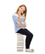 © Syda Productions - little student girl sitting on stack of books