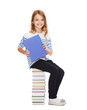 © Syda Productions - little student girl sitting on stack of books