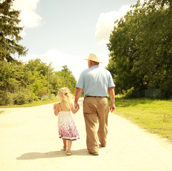 Grandfather and granddaughter are on the road