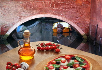 Wall Mural - Classic Italian pizza in Venice against canal, Italy