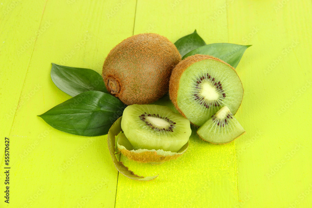 Ripe kiwi on green wooden table close-up