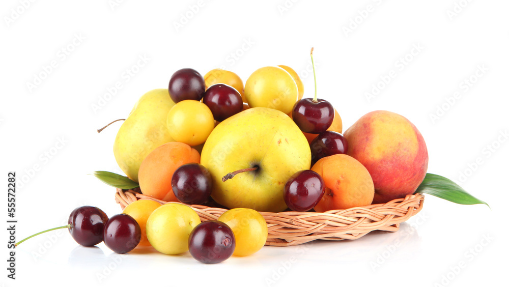 Bright summer fruits in basket isolated on white