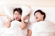 Young woman disturbed by the snores of her husband