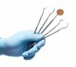 Hand with professional dental tools.