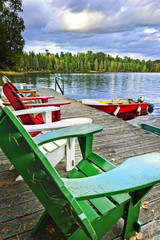 Wall Mural - Deck chairs on dock at lake