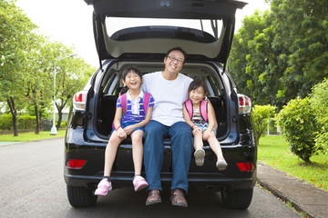 Wall Mural - happy family sitting in the car