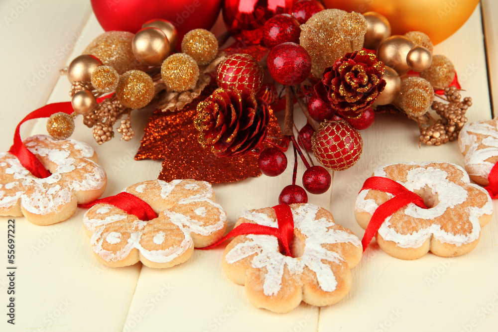 Christmas cookies and decorations on color wooden background