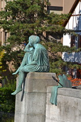 Sitting Helvetia statue on the river Rhine in Basel, Switzerland