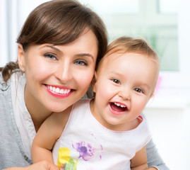 Fototapete - Happy Smiling Mother and Baby kissing and hugging at Home