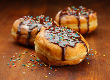 Tasty Donuts With Chocolate On Wooden Table