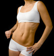 © Ermolaev Alexandr - Close up woman slim body. isolated on dark background
