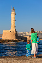 Family Looking At Lighthouse In Chania, Greece