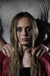 © grufnar - abused woman with man standing behind her vertical