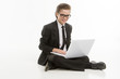 © BlueSkyImages - Little businessman with laptop. Cheerful little boy in formalwea