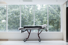 Empty Stretcher In A Hospital By Glass Windows, No People