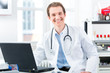 © Kzenon - Portrait of young doctor in clinic on laptop