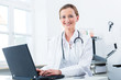 © Kzenon - Female doctor writing on Pc in her clinic