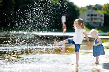 Sticker - Two little sisters having fun by a river