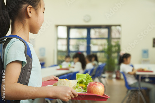 Fotografie, Obraz School girl holding food tray in school cafeteria