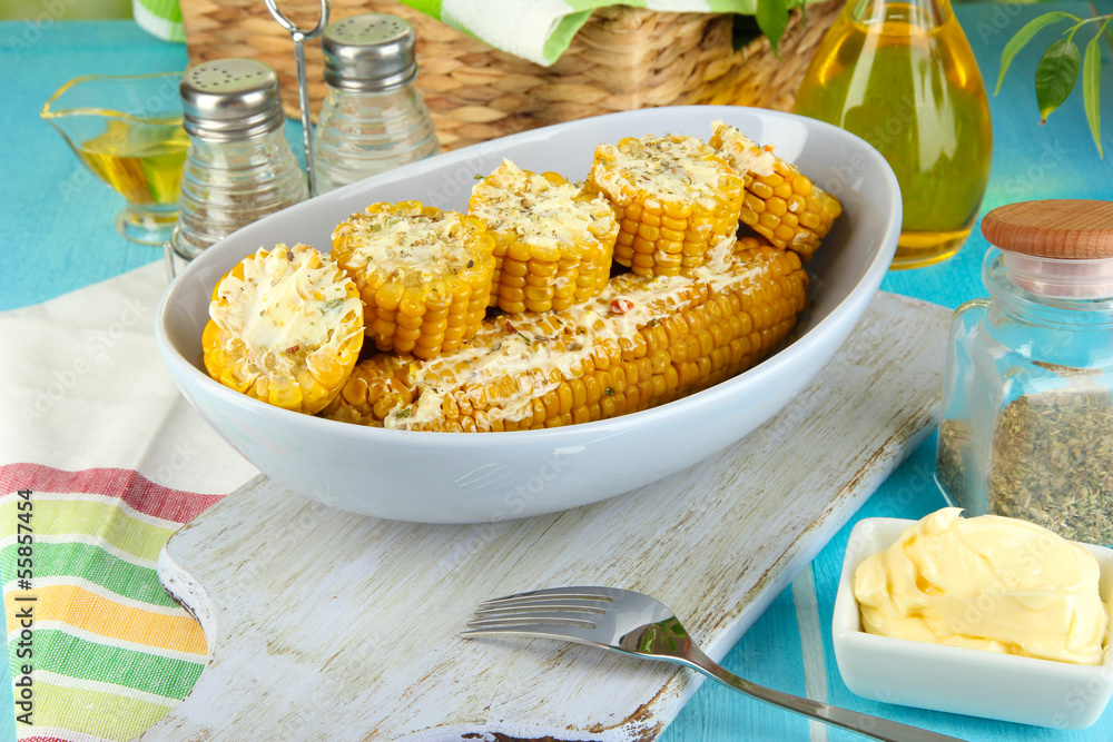 Flavored boiled corn on  plate on wooden table close-up