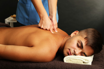 Sticker - Young man having back massage close up