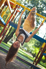 Wall Mural - Young woman in the playground upside down