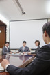© xixinxing - Businesspeople at a Meeting in a Conference Room