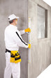 © csimagemakers - Worker measuring with a level tool