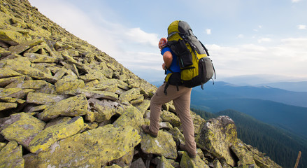 Wall Mural - Hiker makes his way in Carpathian mountains