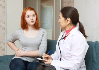 Wall Mural - young  patient complaining of pain in side to doctor