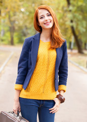 Wall Mural - Girl with suitcase at autumn outdoor