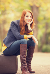 Sticker - Girl with suitcase at autumn outdoor