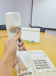 Hand picking telephone up on call in office