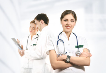 Canvas Print - A team of young and smart medical workers in white clothes