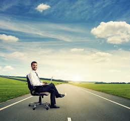 Wall Mural - man with laptop on the road