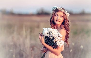 beautiful girl in a camomile wreath