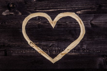 Сarved Heart On Dark Wood Background