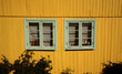 canvas print picture - Yellow wooden wall with two windows.