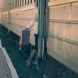 Fashionable woman entering inside train car