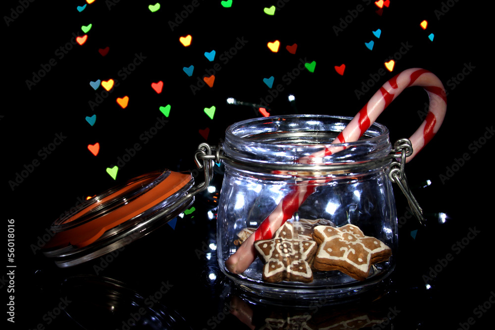 Tasty cookies  in glass bottle on blur lights background