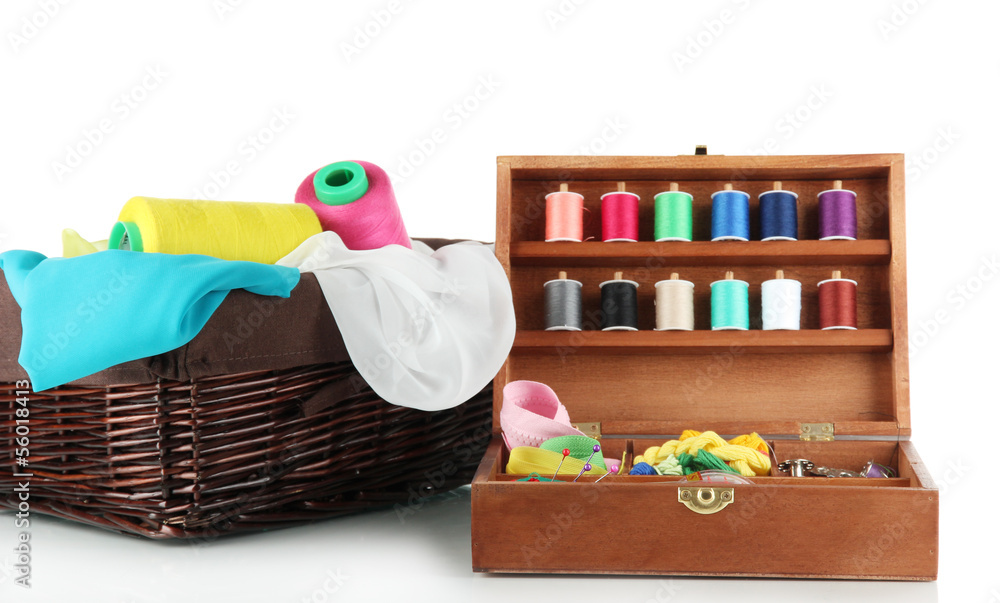 Sewing kit in wooden box and basket with cloth isolated on