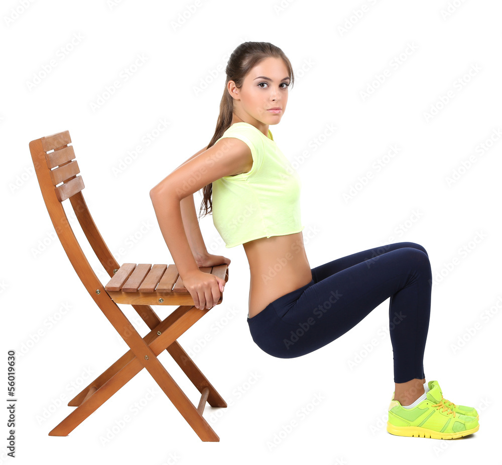 Beautiful young girl doing exercises isolated on white