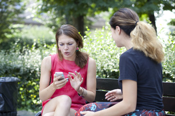 Young woman resting on a bench in the park